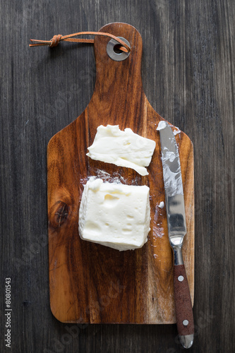 Creamy Italian Stracchino Cheese on the Wooden Cutting Board