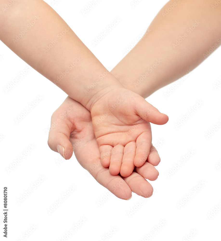 close up of woman and little child hands together close up of woman and little child hands together