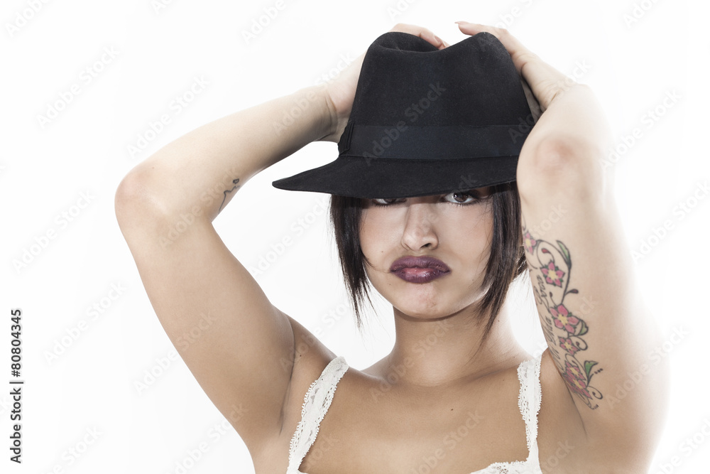 Beautiful woman grouching and wearing black hat Beautiful woman grouching and wearing black hat