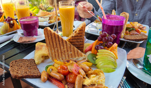 Colorfully covered brunch table at an outdoor cafe