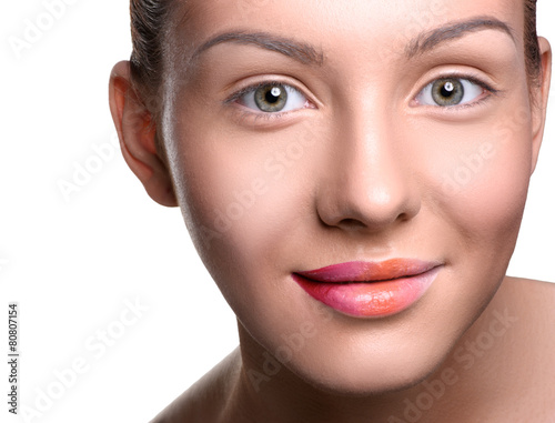 Close up head shot of beautiful young woman looking at the