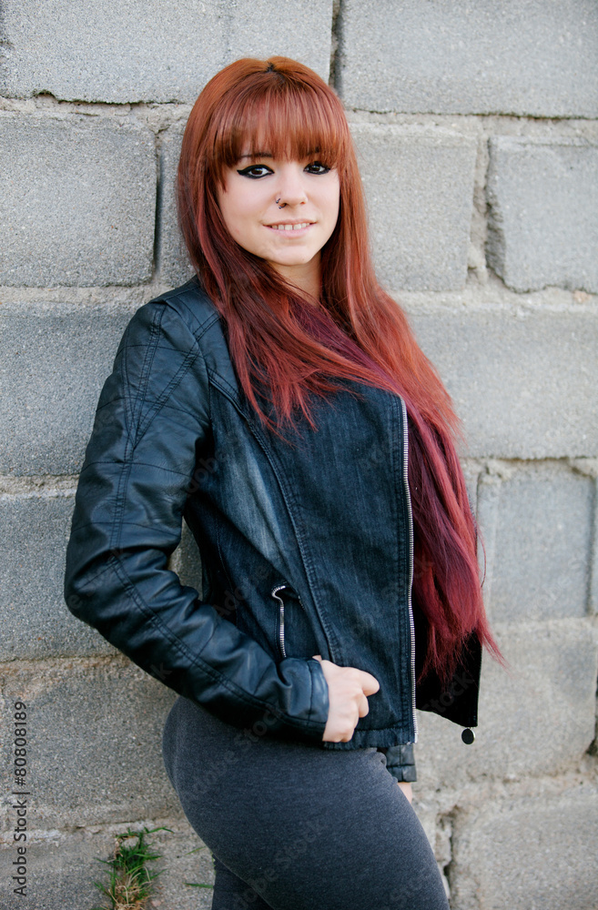 Rebellious teenager girl with red hair smiling Rebellious teenager girl with red hair smiling
