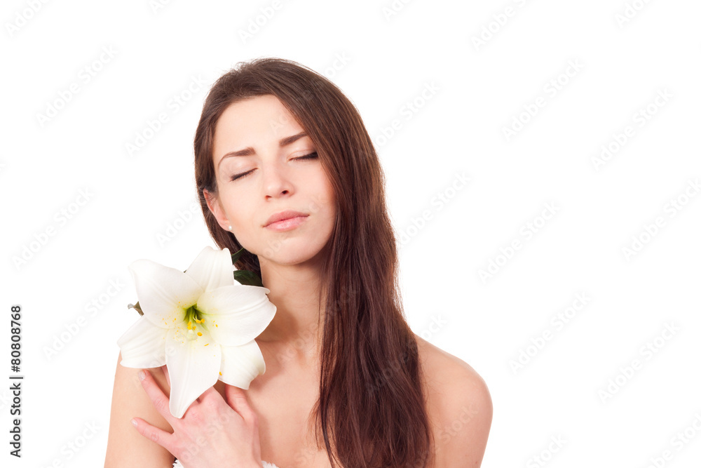 portrait of beautiful woman with perfect skin holding lily