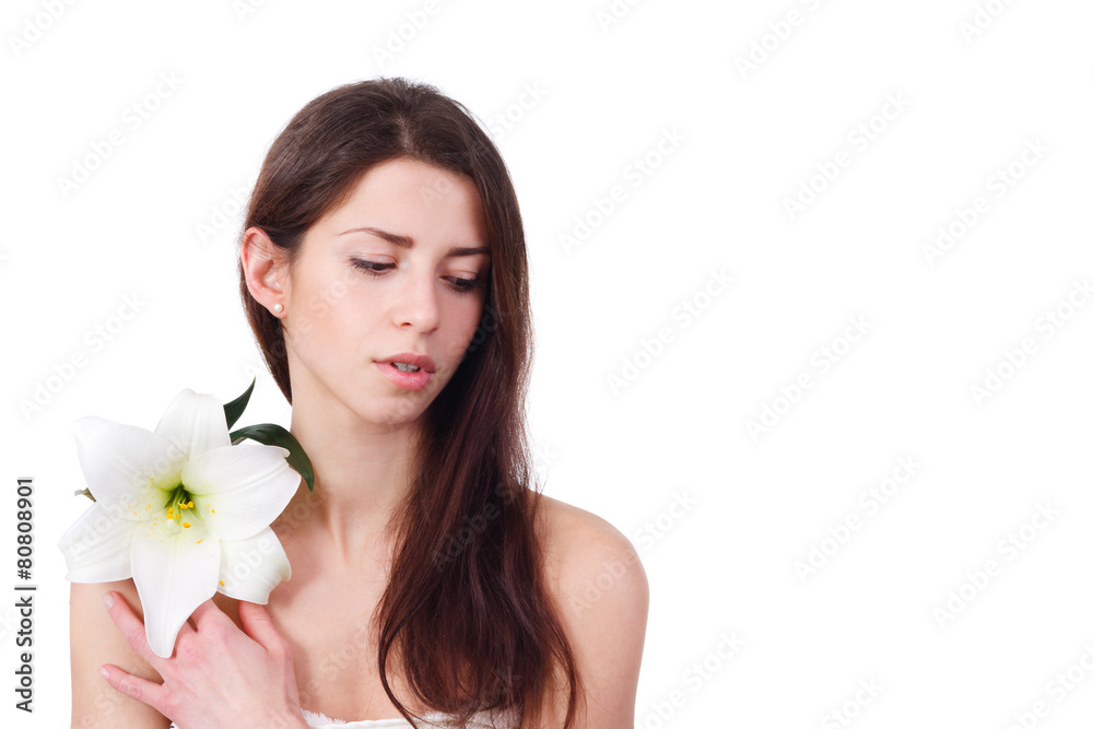 portrait of beautiful woman with perfect skin holding lily