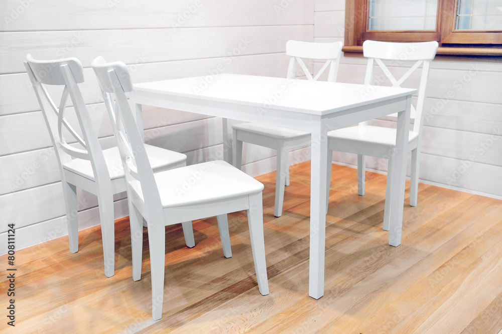 Fototapeta premium Wooden white dining table and four chairs