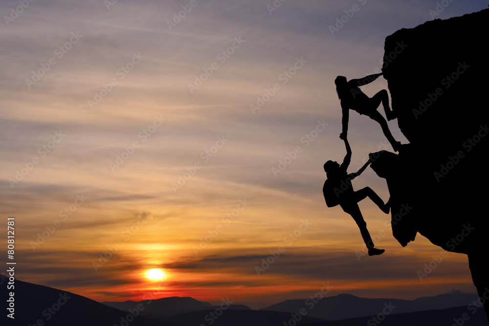 Teamwork of two people man and girl on mountain