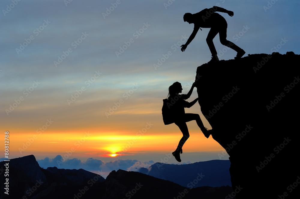 Teamwork of two people man and girl on mountain