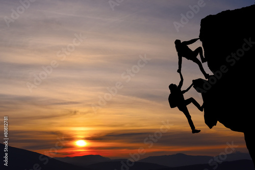 Teamwork of two people man and girl on mountain