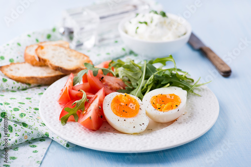 Breakfast with soft-boiled egg  arugula and tomatoes