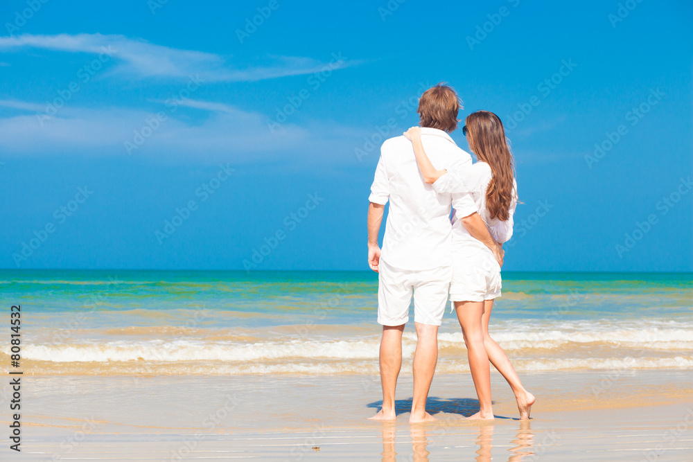 happy young couple in white clothes having fun on tropical beach happy young couple in white clothes having fun on tropical beach