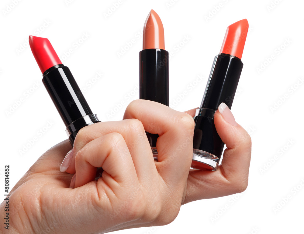 Different lipsticks in hand Different lipsticks in hand