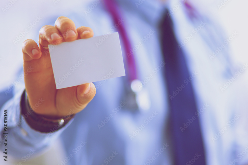 Male doctor holding empty white card Male doctor holding empty white card