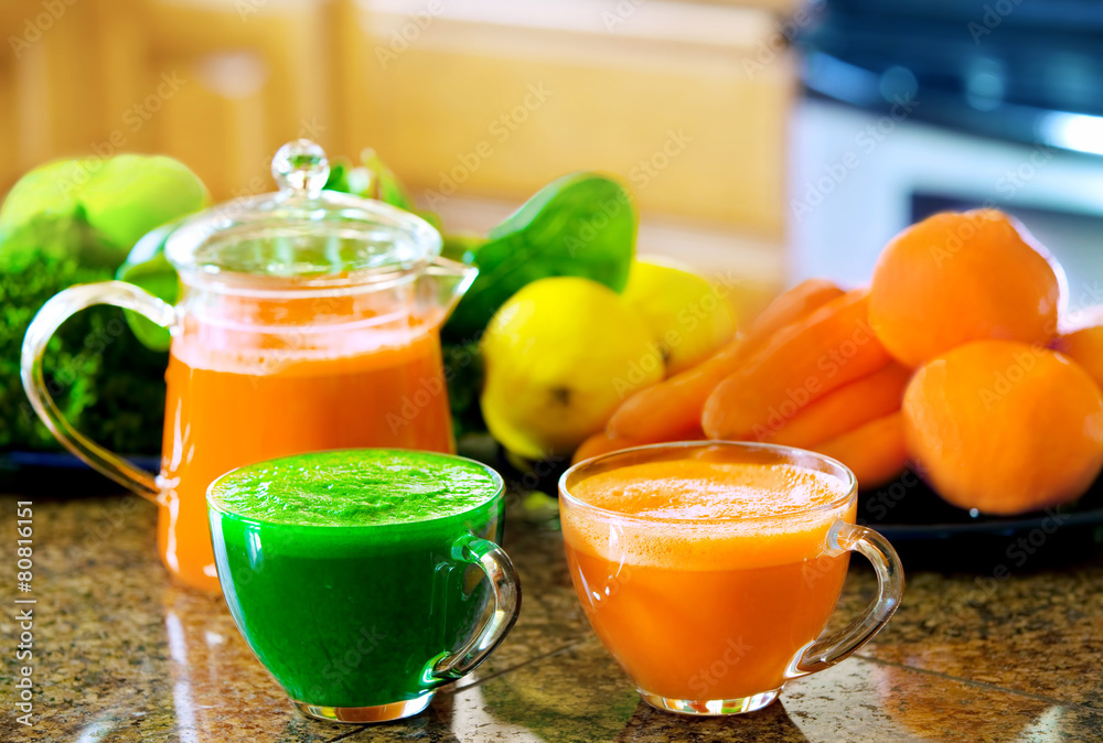 Two cups of fresh vegetable juice on kitchen counter with vegeta Two cups of fresh vegetable juice on kitchen counter with vegeta