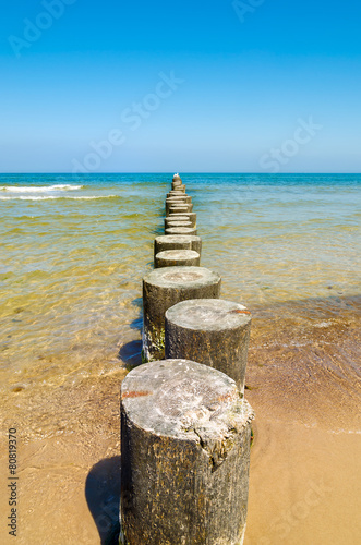Wooden breakwater on beach in Ustka town, Baltic Sea, Poland #80819370