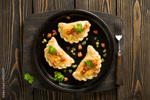 Fried dumplings with onion and bacon top view
