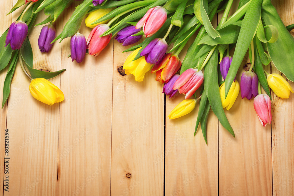 Spring Flowers bunch at wood floor texture. Beautiful Tulips bou