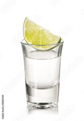 A shot of tequila with lime
