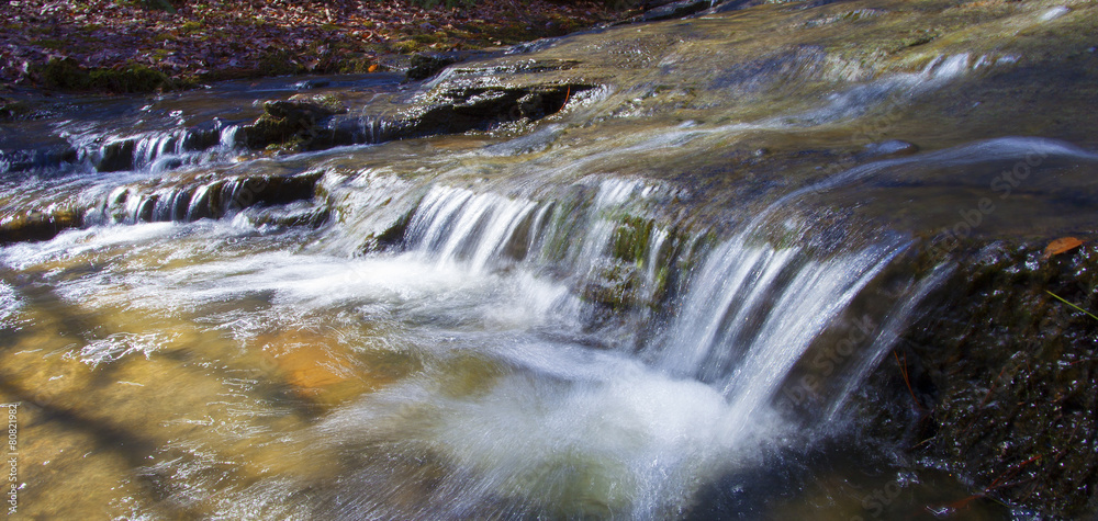 Small stream rolling down some rocks Small stream rolling down some rocks