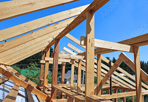 Installation of wooden beams at construction the roof truss syst photo