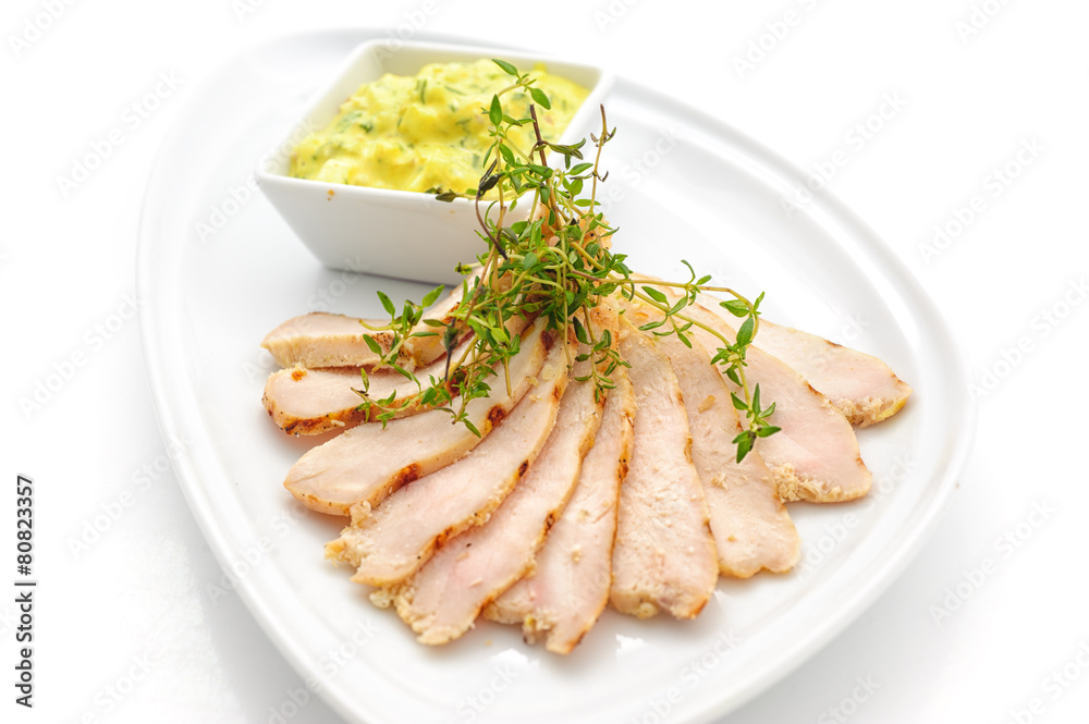 Sliced ham with yellow sauce studio shot