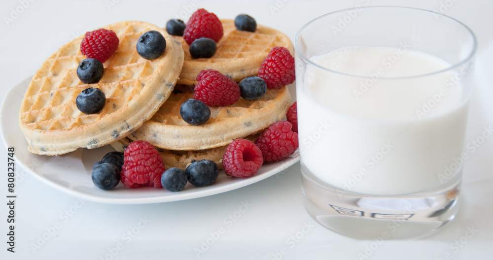 Breakfast. Waffles with berries and milk Breakfast. Waffles with berries and milk