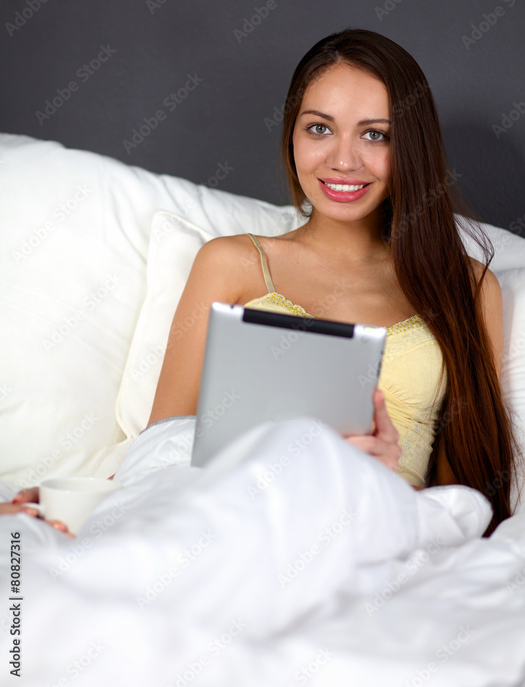 Women use a tablet pc on the bed Women use a tablet pc on the bed
