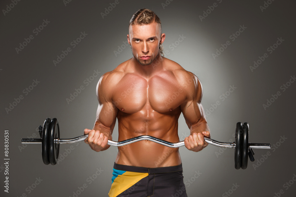 Portrait of super fit muscular young man working out in gym. Portrait of super fit muscular young man working out in gym.