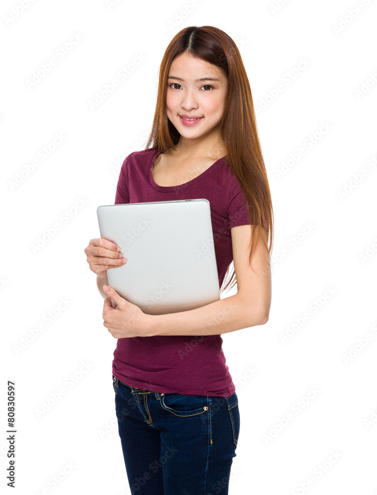 Attractive smiling young woman holding laptop computer Attractive smiling young woman holding laptop computer