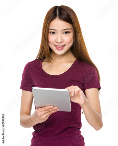 Smiling asian young woman watching the tablet pc