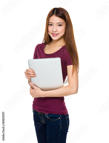 Attractive smiling young woman holding laptop computer