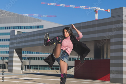 Beautiful young brunette posing in the city streets