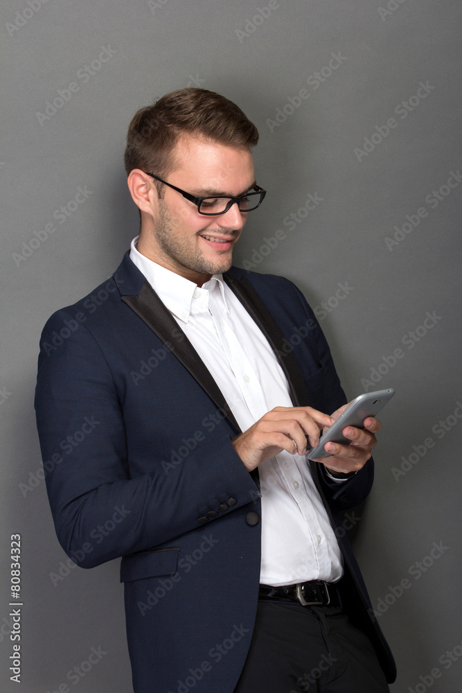 Young businessman with a cellphone on his hand Young businessman with a cellphone on his hand