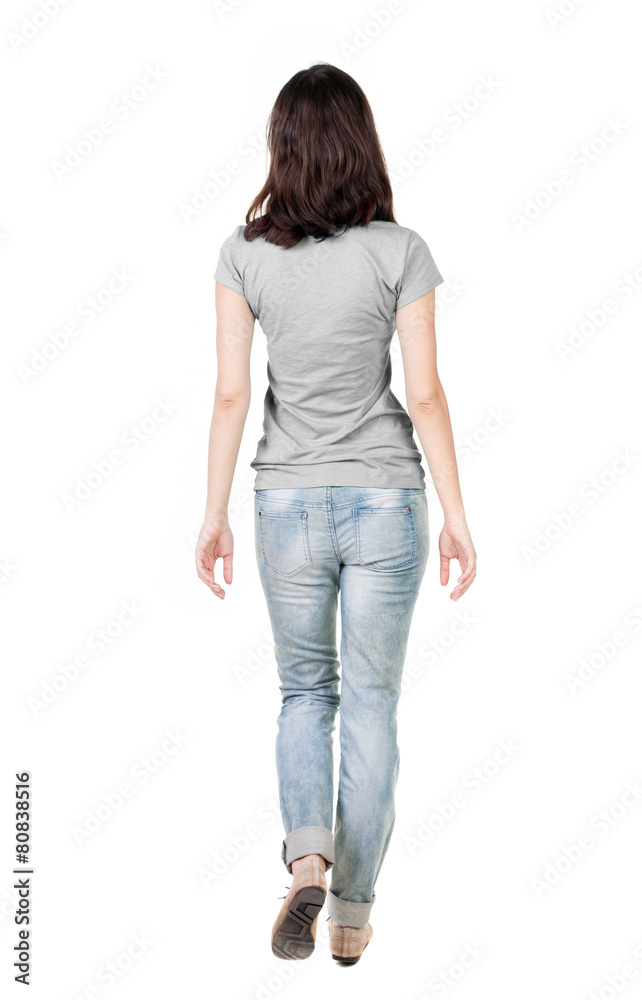 Fototapeta premium back view of walking woman in jeans .