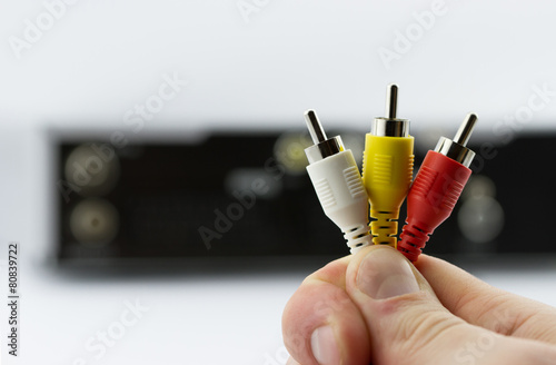 AV cable connectors in hand with AV receiver