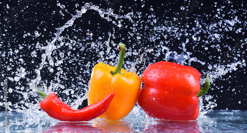 Wet red and yellow pepper closeup. Macro water drops