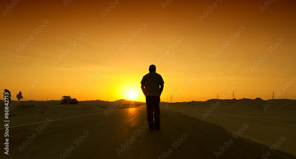 Man walking on the Dubai desert road