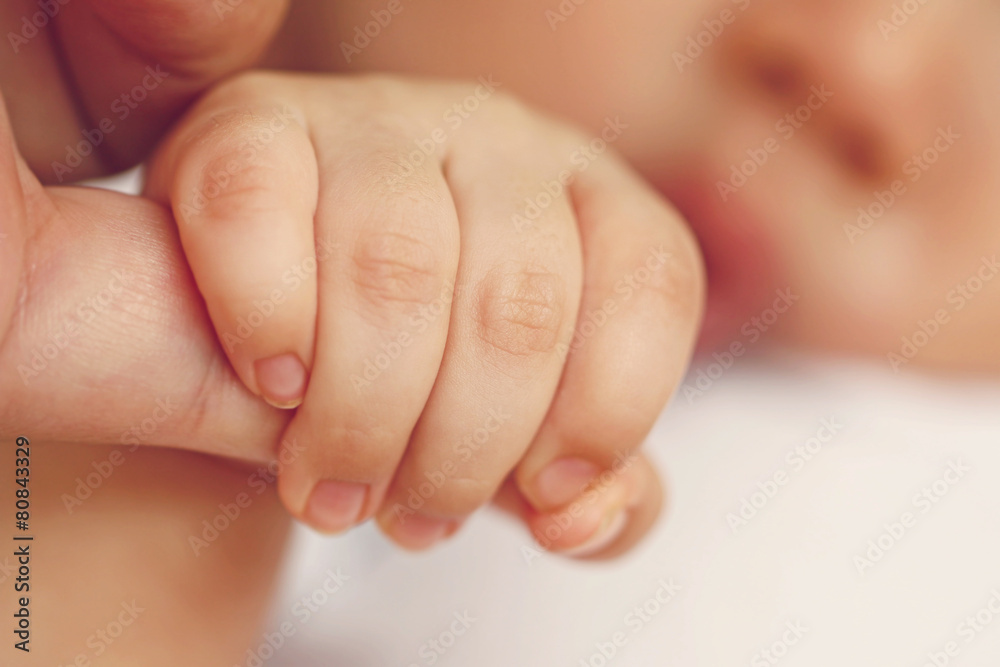 Newborn baby holding mother's hand, image with shallow depth of Newborn baby holding mother's hand, image with shallow depth of