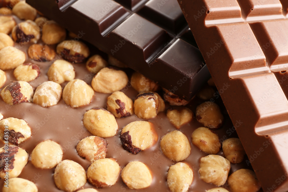 Black and milk chocolate bars with hazelnuts close up Black and milk chocolate bars with hazelnuts close up