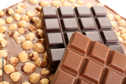 Black and milk chocolate bars with hazelnuts close up