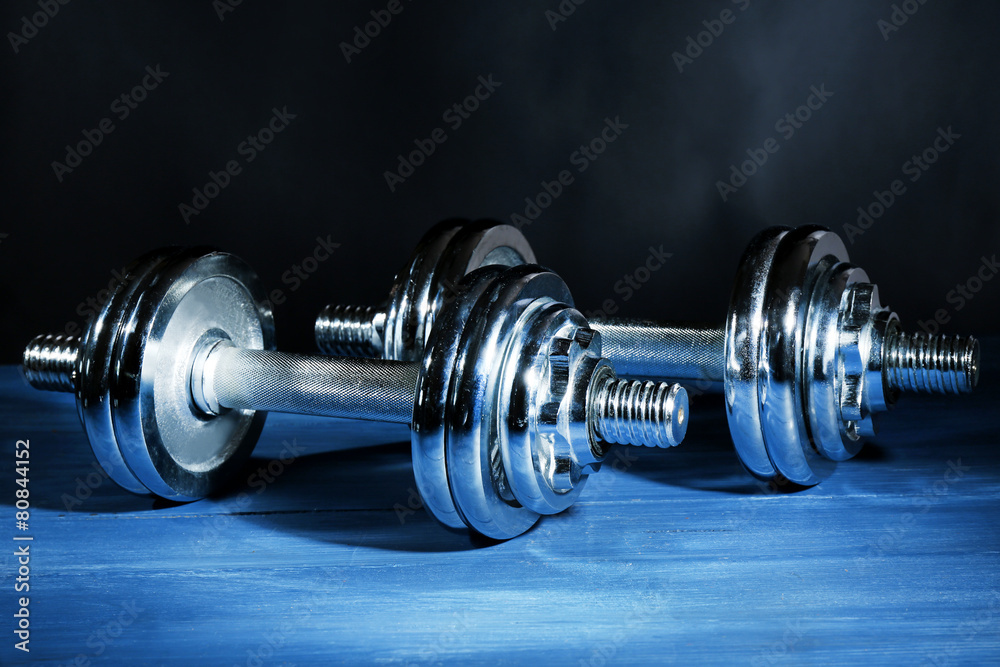 Dumbbells on dark color background Dumbbells on dark color background