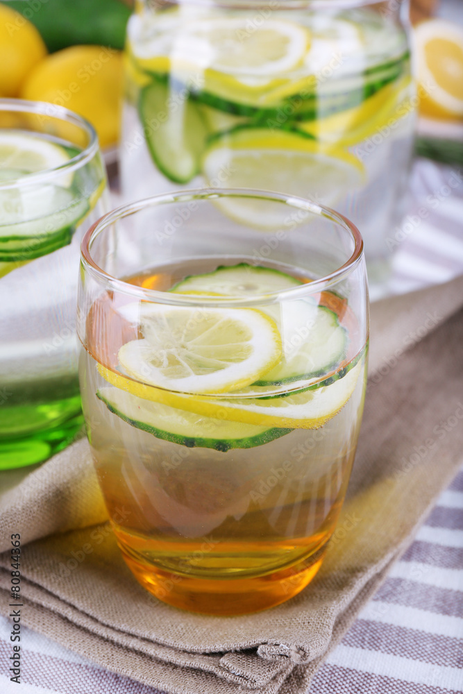 Fresh water with lemon and cucumber in glassware Fresh water with lemon and cucumber in glassware