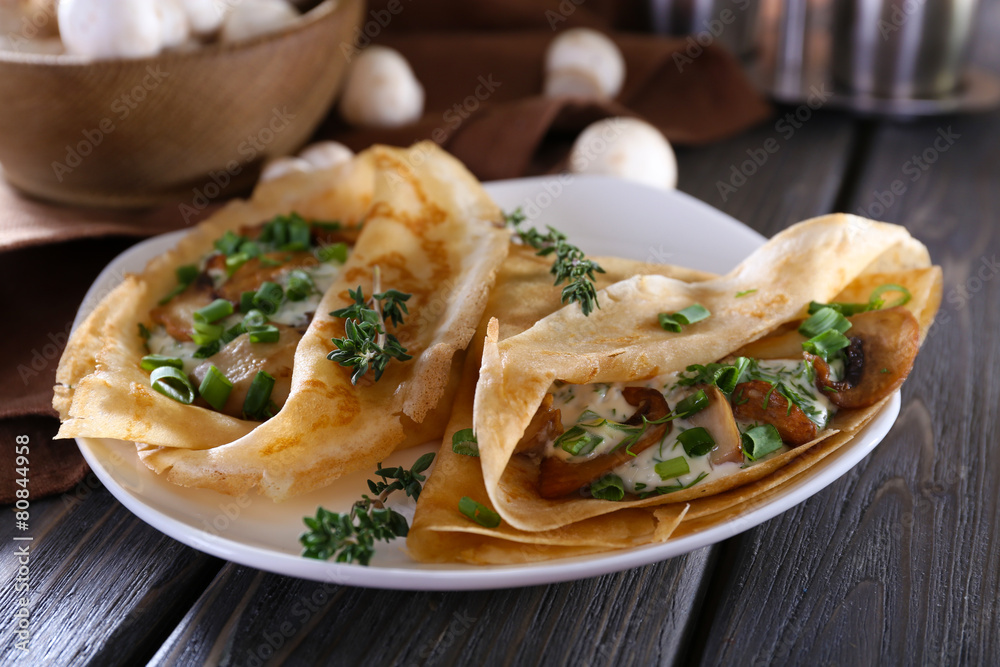 Pancakes with creamy mushrooms in plate on wooden table, Pancakes with creamy mushrooms in plate on wooden table,
