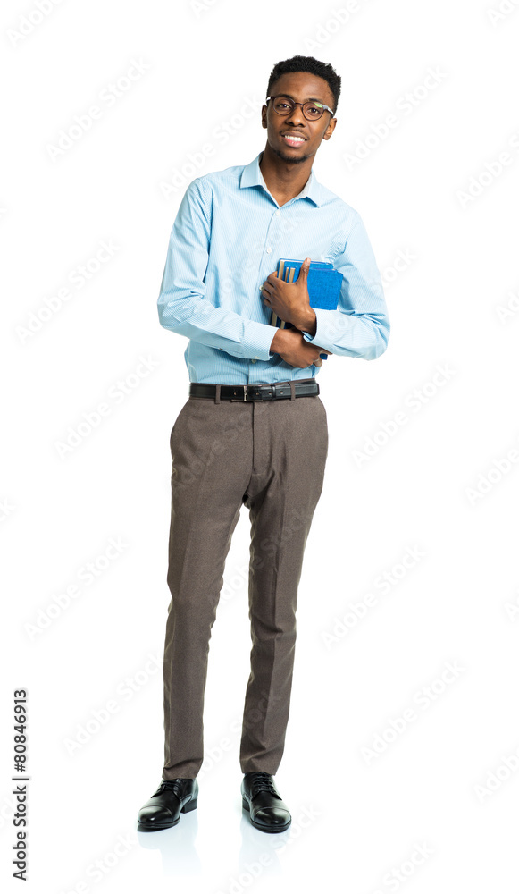 Happy african american college student with books standing on wh Happy african american college student with books standing on wh