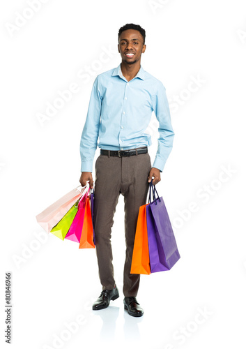 Happy african american man holding shopping bags on white backgr