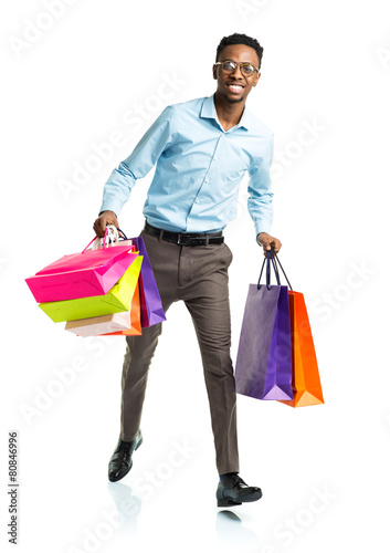 Happy african american man holding shopping bags on white backgr