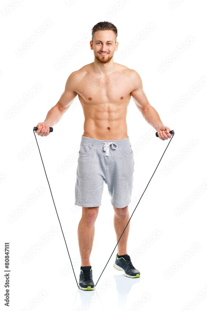Athletic attractive man jumping on a rope on the white Athletic attractive man jumping on a rope on the white