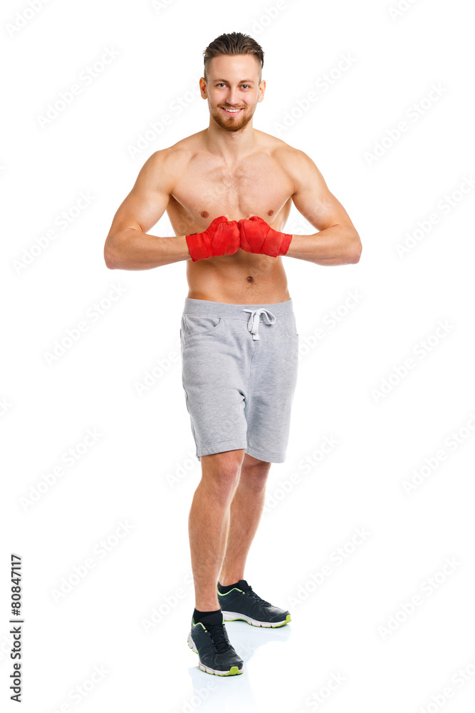 Athletic attractive man wearing boxing bandages on the white