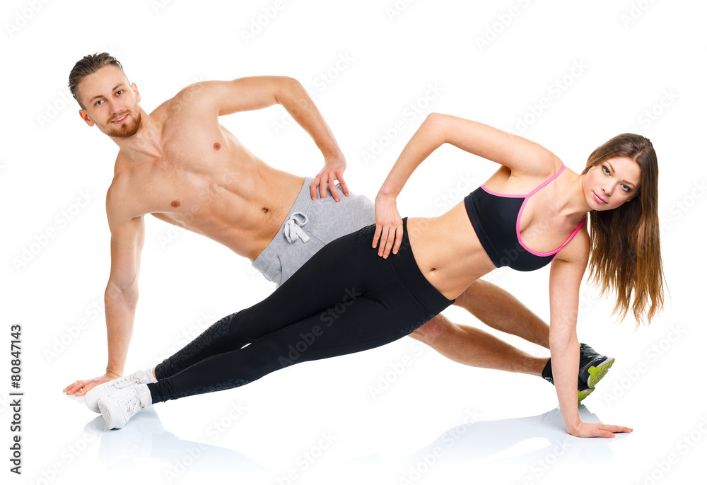 Obraz premium Attractive sport couple - man and woman doing fitness exercises
