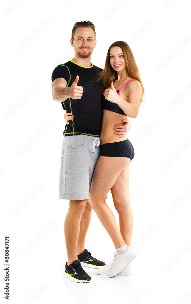 Athletic man and woman after fitness exercise with a finger up o Athletic man and woman after fitness exercise with a finger up o
