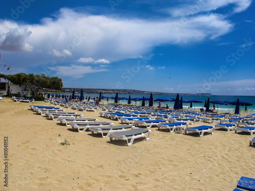 ready blue sunbeds on the beach in Cyprus